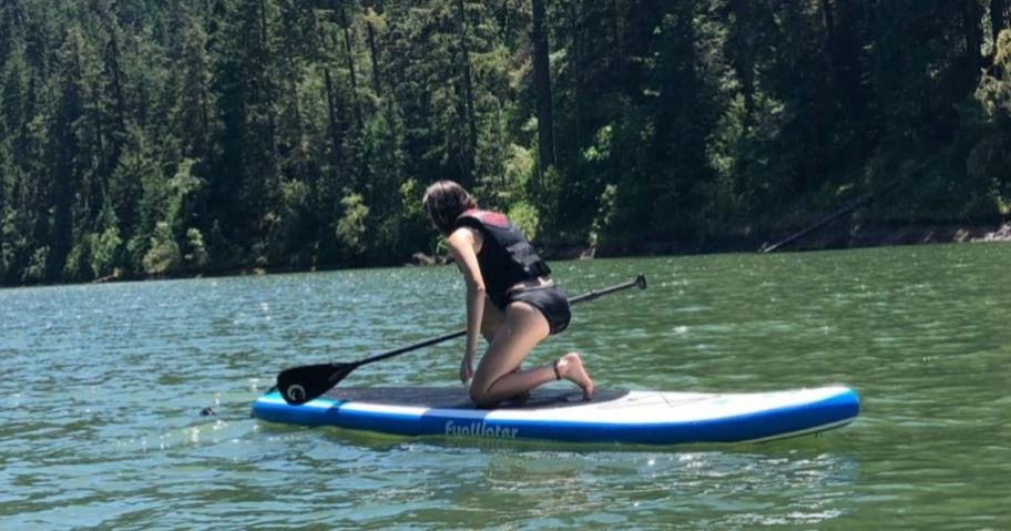 A person on a FunWater Stand Up Paddle Board White and Blue