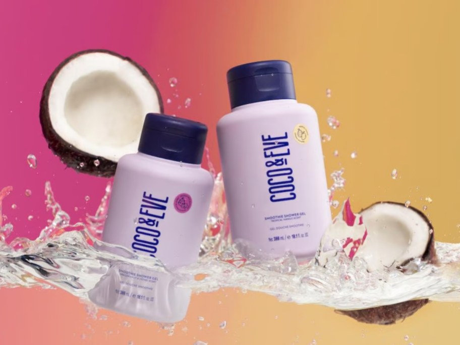 2 bottles of Coco & Eve Smoothie Shower Gel being dropped in water with coconut halves on each side