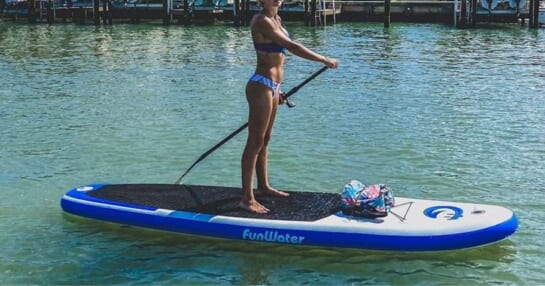 A woman on a FunWater Stand Up Paddle Board in White and Blue