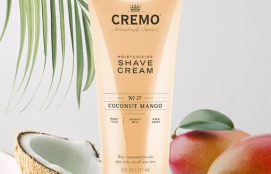 Cremo coconut mango shaving cream top image with a coconut and mango around it