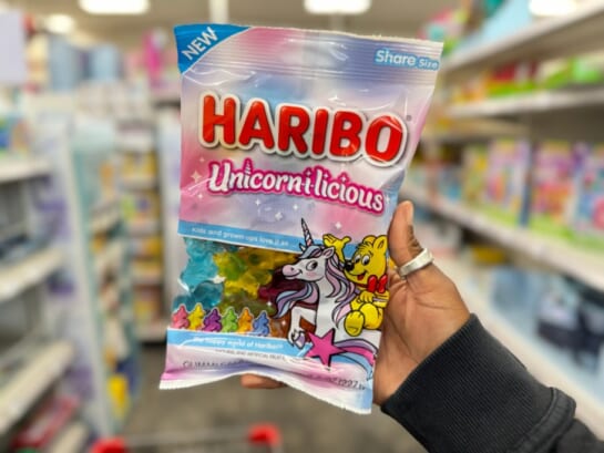 Hand holding a package of Haribo Unicorn Gummies