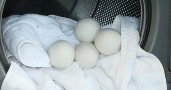 A dryer with towels and wool dryer balls